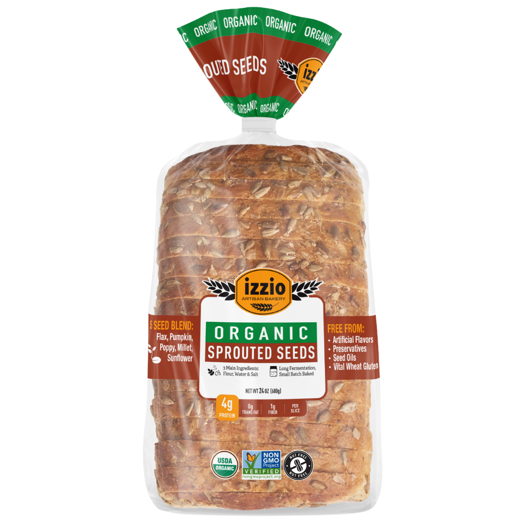 A loaf of Izzio Organic Sprouted Seeds bread in a clear plastic bag with a green, brown, and white label, isolated on a white background.