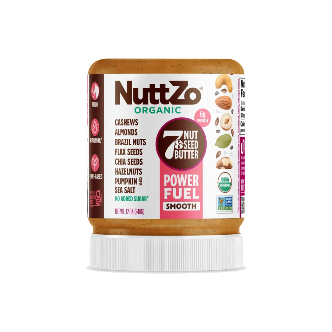 A jar of NuttZo Organic 7 Nut & Seed Butter in the Power Fuel Smooth flavor, featuring a white lid and a label with brown, white, and pink sections, set against a plain white background.